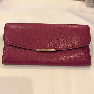 Coach maroon wallet. Snap close with zippered change area.